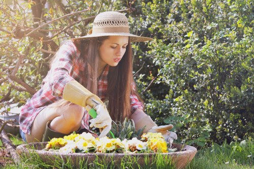Expert gardener trimming hedges in a well-maintained garden